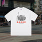 White t-shirt with graphic design and text on a city street background